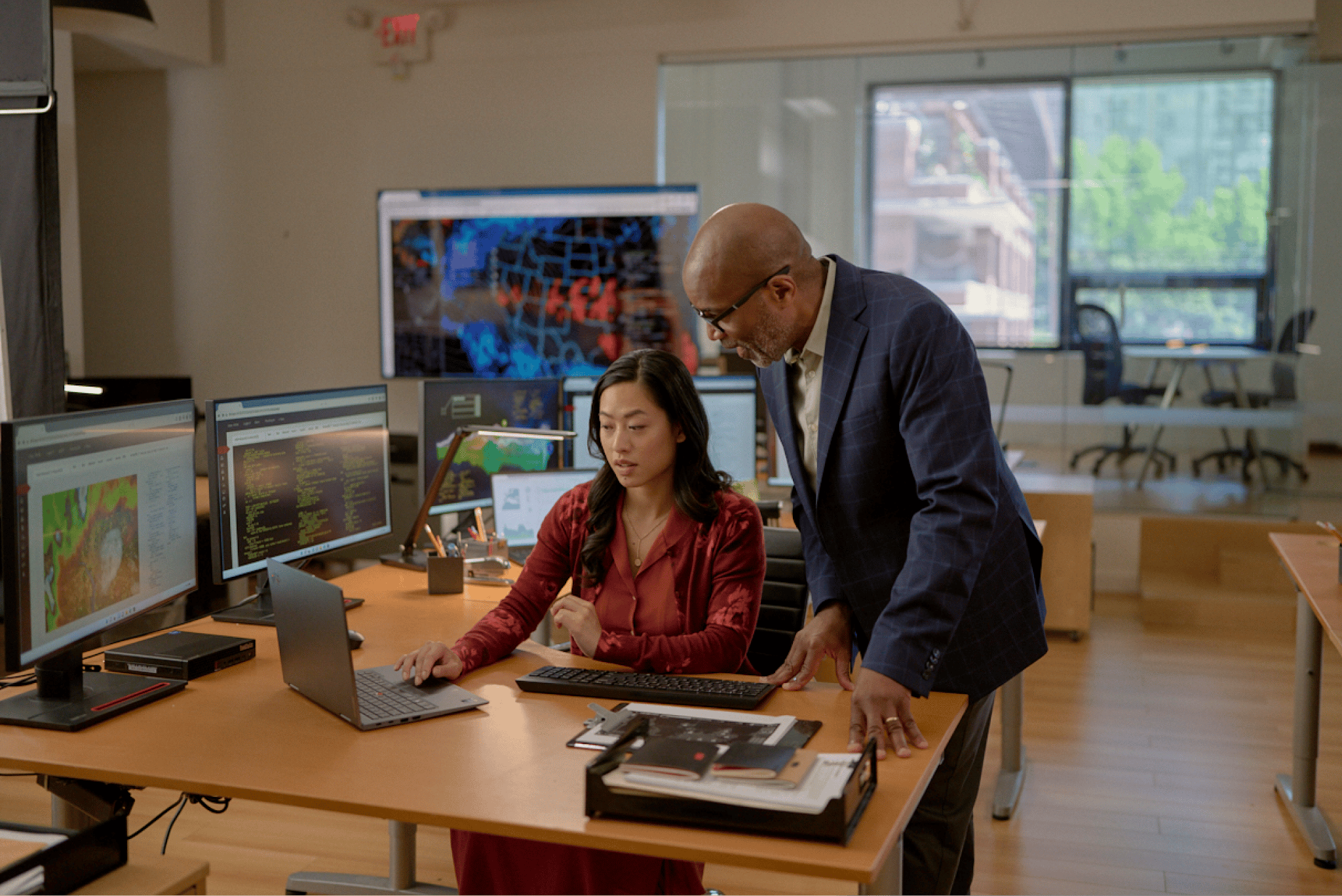 Two people looking over a laptop