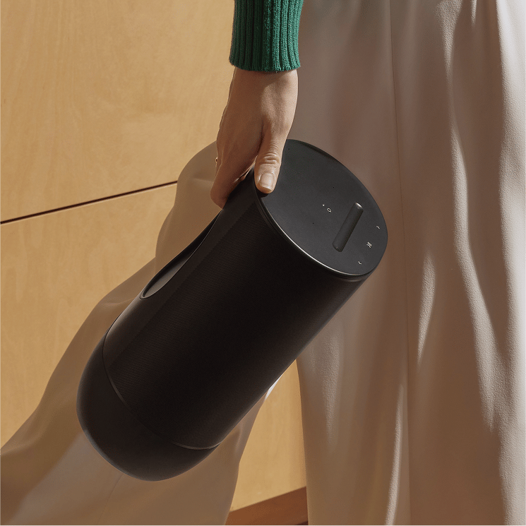 Woman walking with Sonos speaker
